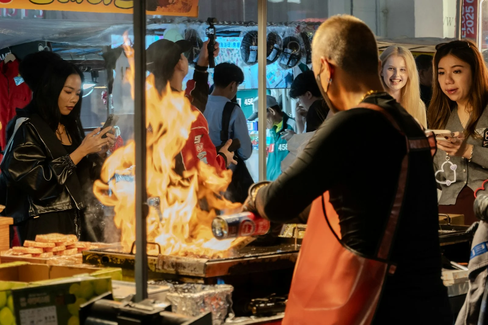 Street food vendor cooking over open flames at night in Myeongdong, Seoul