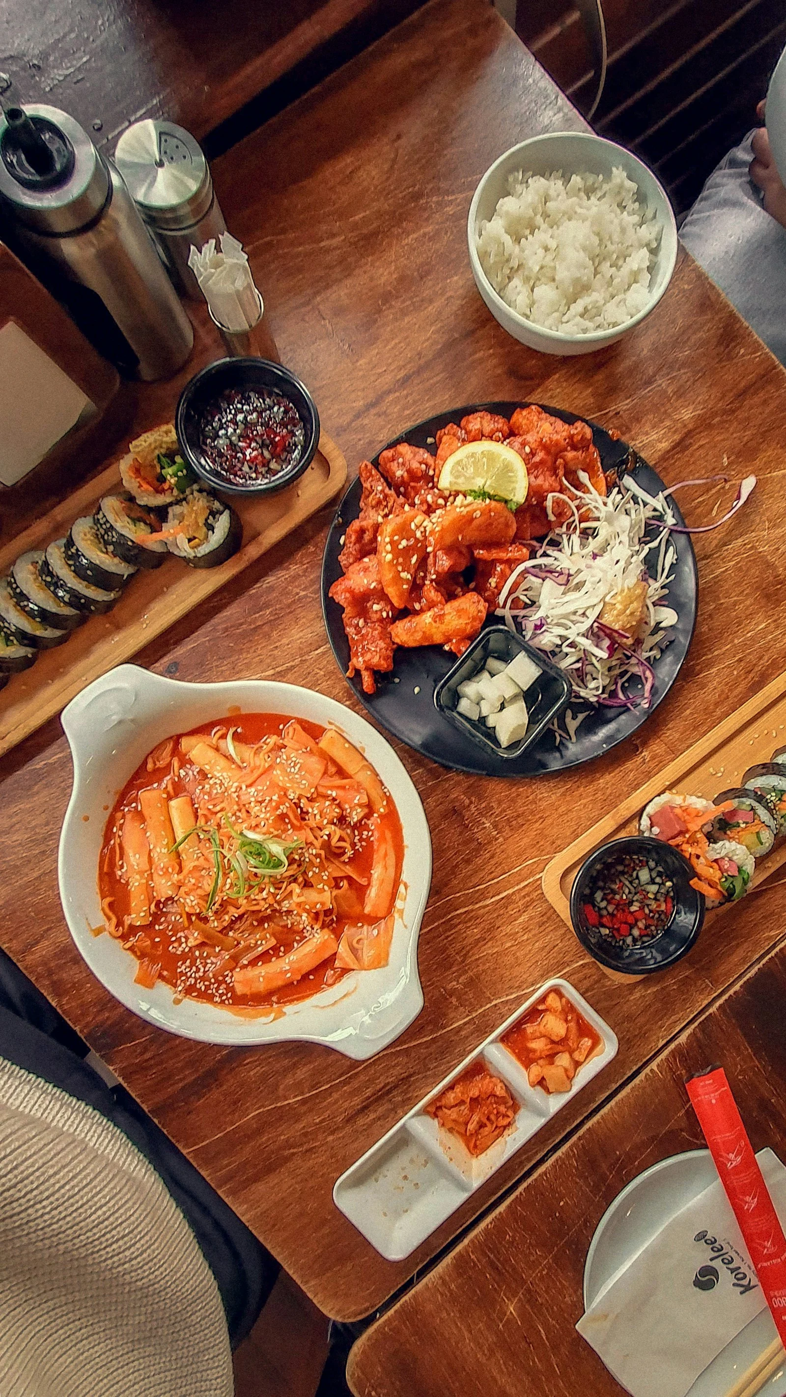 Korean food spread: tteokbokki, kimchi, fried chicken and gimbap