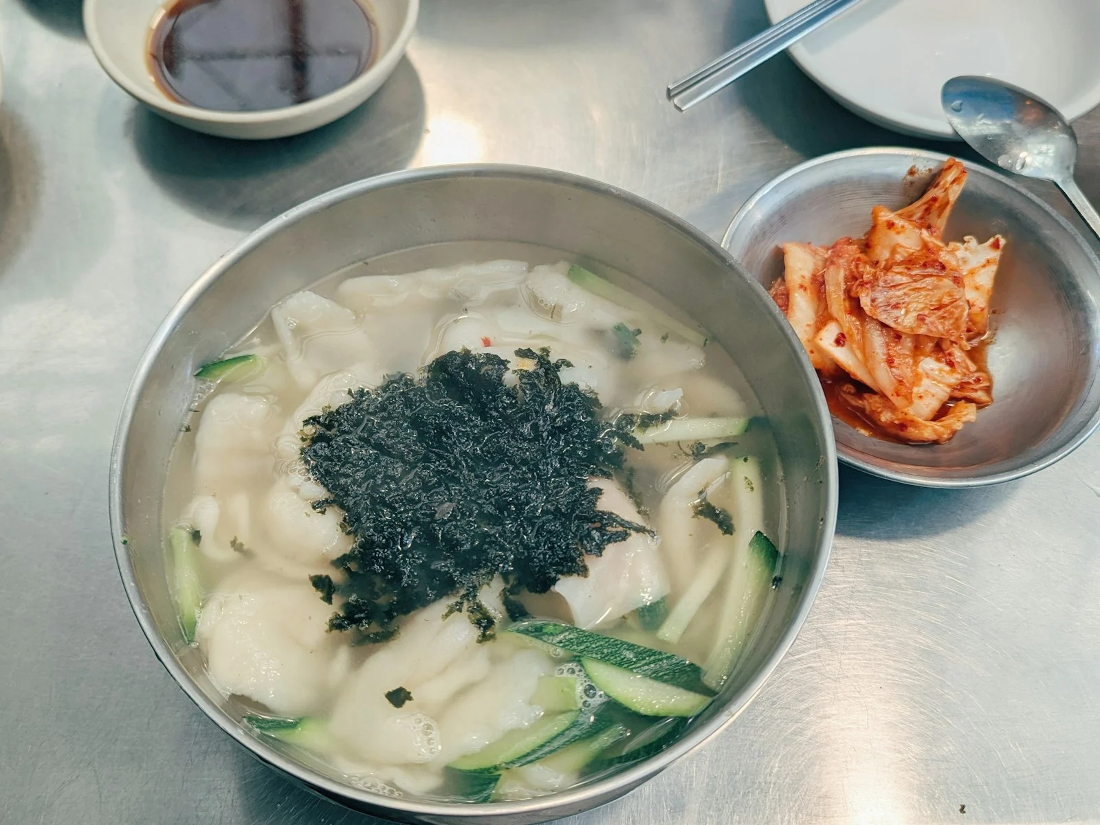 A bowl of kalguksu with kimchi, Seoul