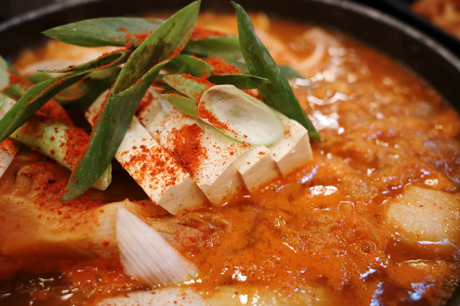 Spicy Korean kimchi stew with tofu and scallions