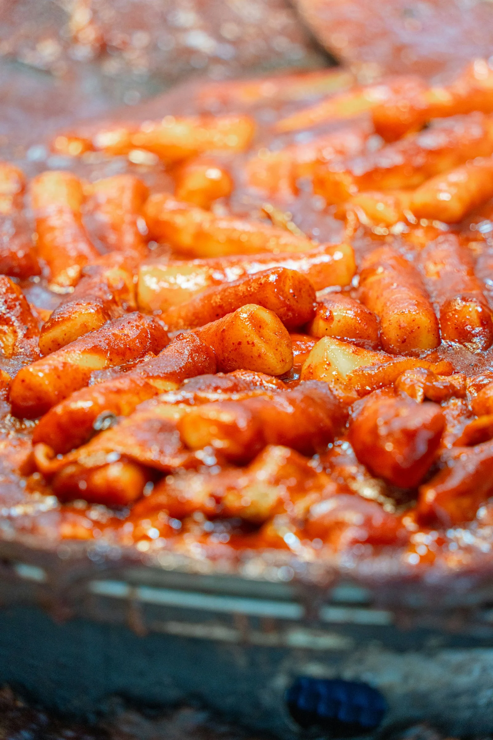 Tteokbokki rice cakes simmering in spicy sauce